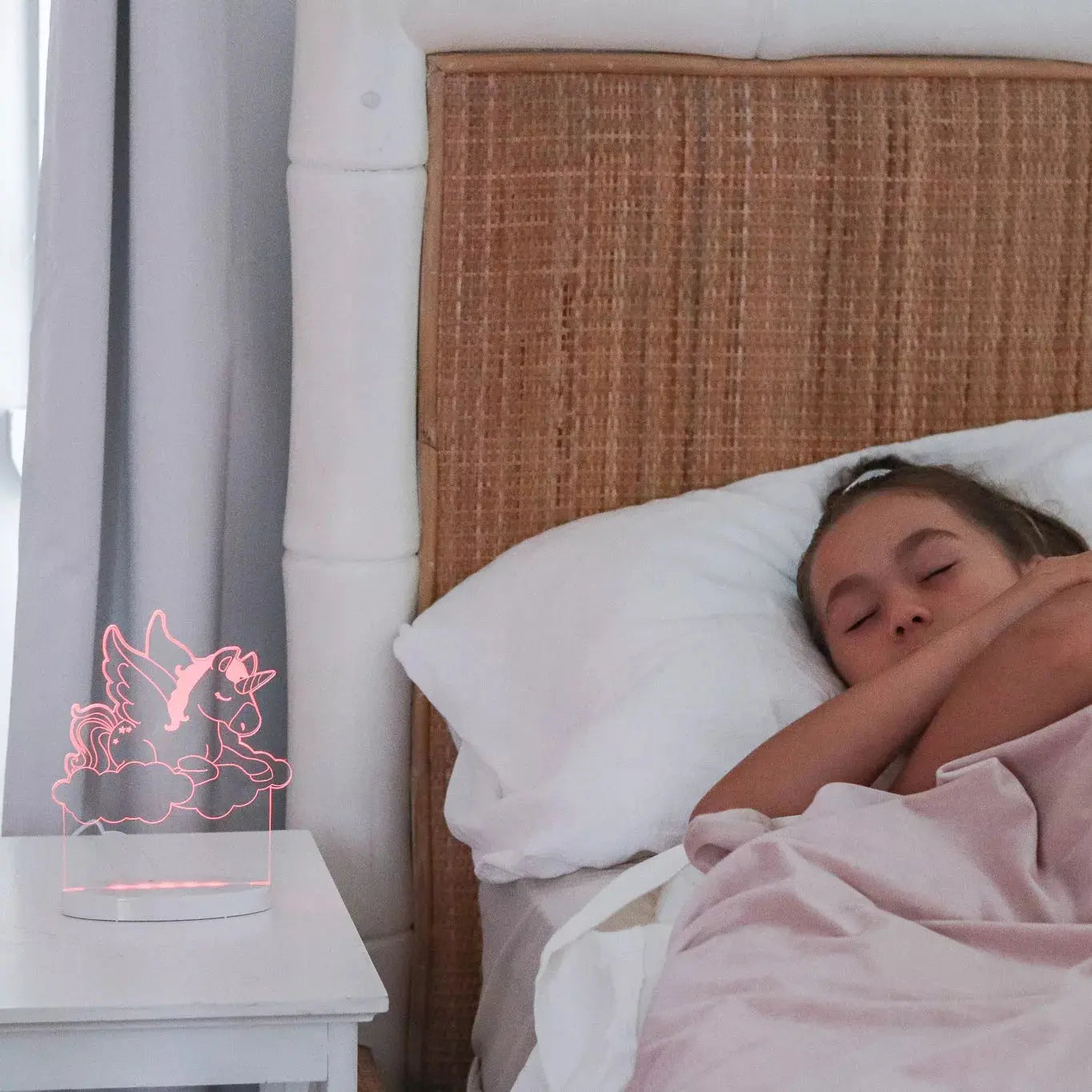 child sleeping with unicorn night light