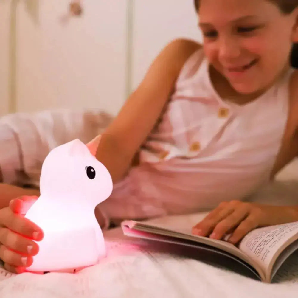 girl readinga book with her book night light