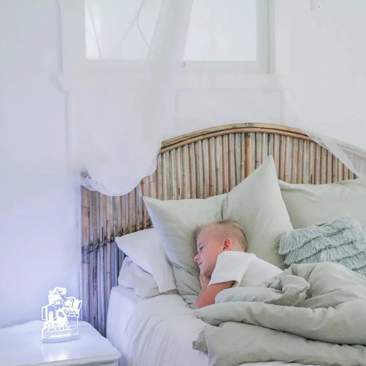 child sleeping with truck night light